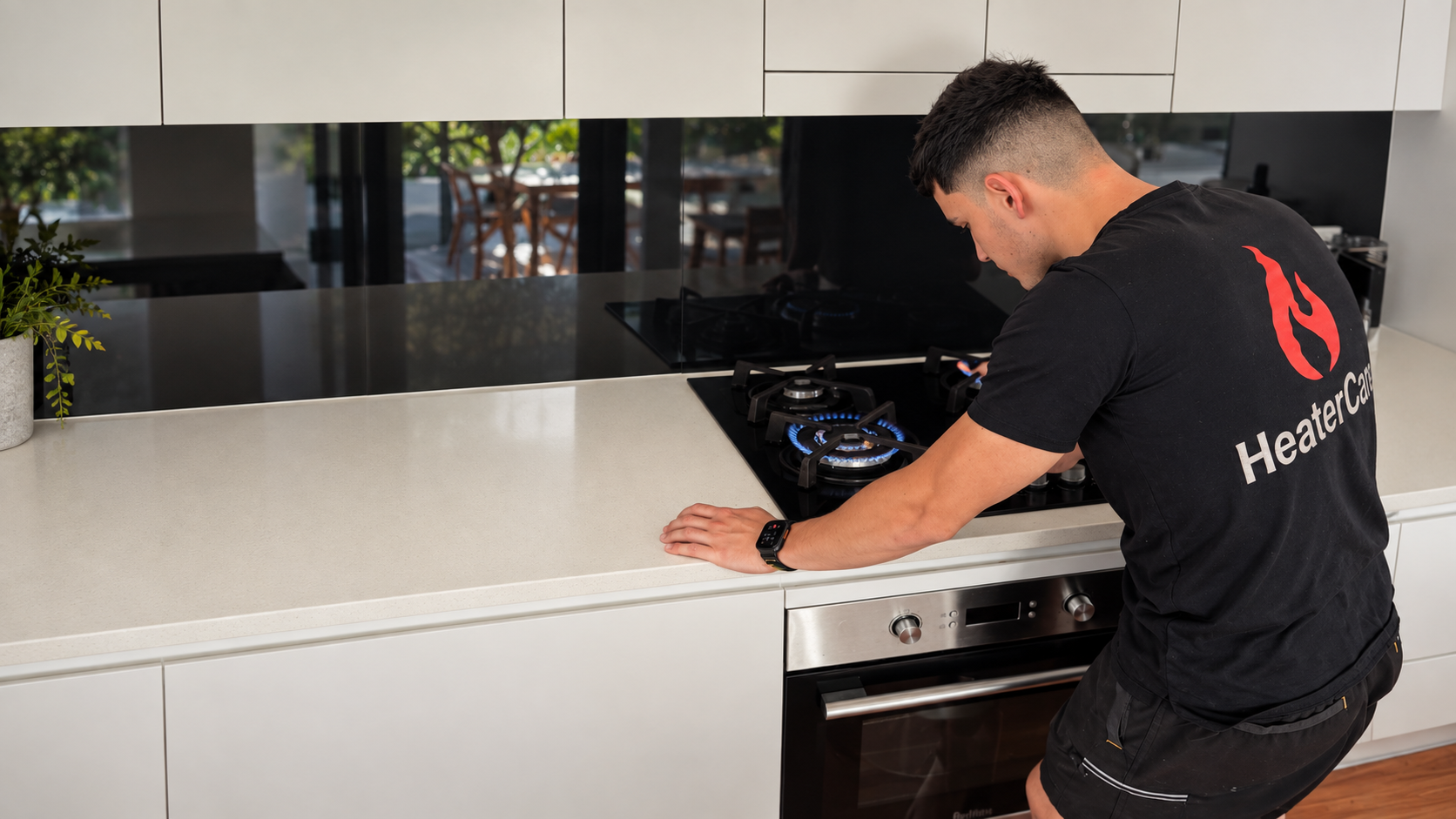 HeaterCare technician working on a gas stove and cooktop
